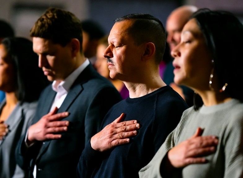 Adoradores com mãos sobre o coração
